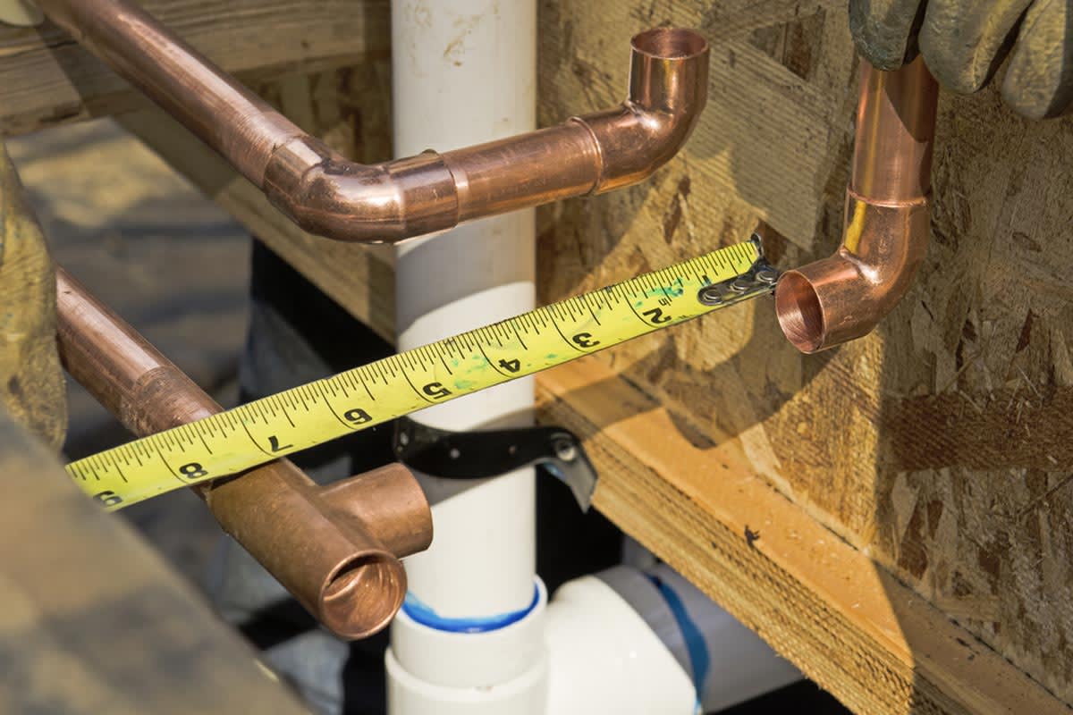 https://alexwaterandbouw.eu/wp-content/uploads/2026/03/homeguide-plumbing-contractor-works-on-the-copper-pipe-domestic-water-system-in-home_mmlpom.jpg